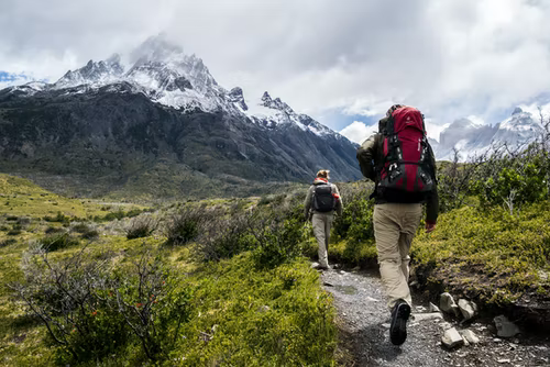 A hiker walking up a mountain ridge